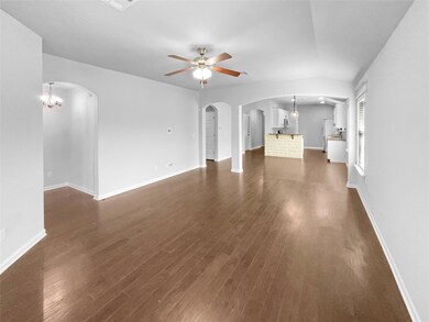 Unfurnished living room featuring arched walkways
