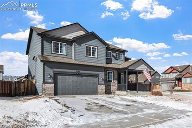 View of front of home featuring a garage and cover