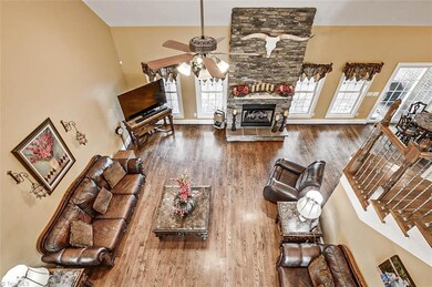 Great room view from landing, beautiful stone fireplace with gas logs