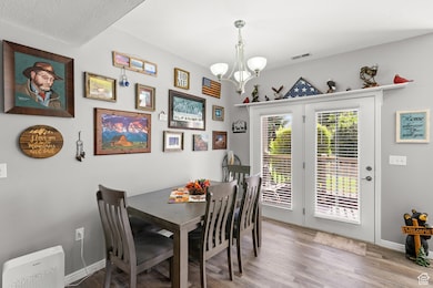 Dining area featuring wood finished floors and a chandelier