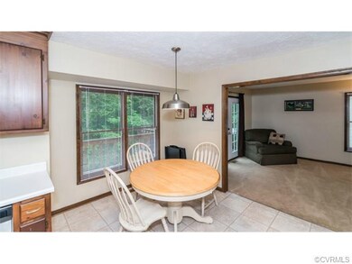 The kitchen features a large eat-in area, which ov