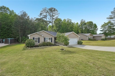 Single story home with concrete driveway, fence, a