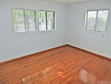 front corner bedroom with refinished hardwood floo