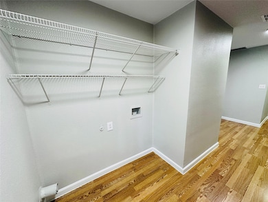 Laundry area with light wood-type flooring, hooku