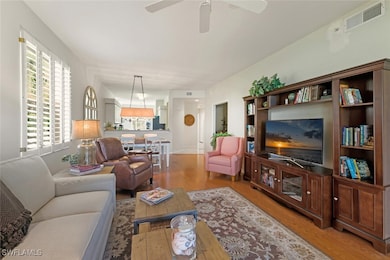 Living room featuring wood finished floors and ceiling fan