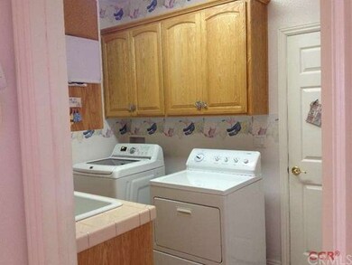 Laundry room with sink to the three car garage