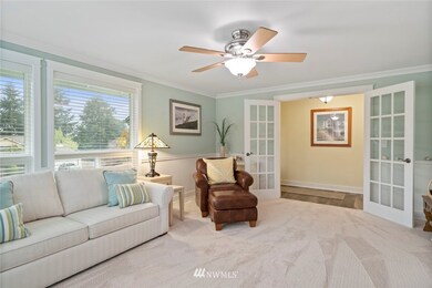 Another view of the family room with french doors and ceiling fan.