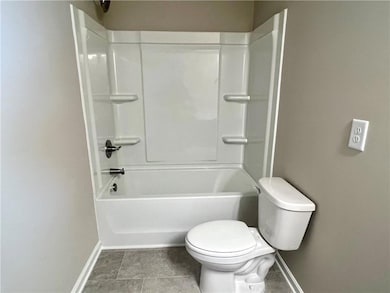 Bathroom featuring toilet, tile patterned flooring
