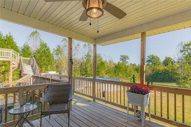 Wooden deck with ceiling fan and a lawn