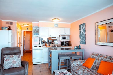 Kitchen featuring crown molding, white appliances,