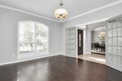 Featuring elegant French doors, this serene space