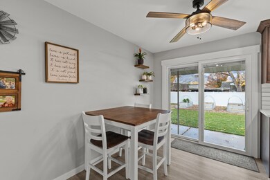 Dining room with light wood-style flooring and ceiling fan