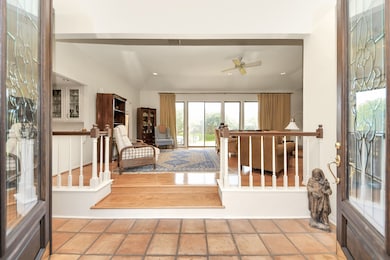 Eight foot leaded glass doors lead into a grand li
