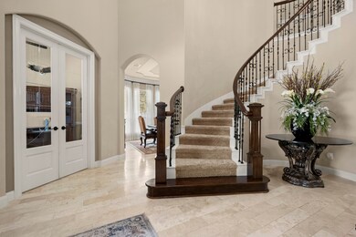 Circle staircase that leads to the media room, game room, upper bedrooms and BALCONY.