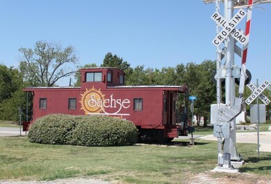 Perpendicular to the Historical Landmark Sachse Red Caboose.
