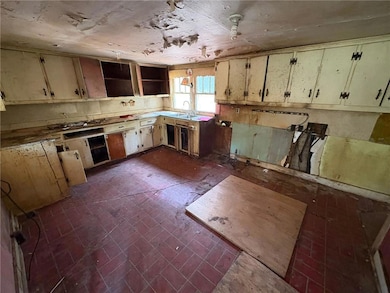 Kitchen featuring open shelves and a sink