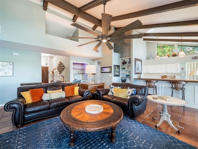 Living room with beam ceiling, high vaulted ceili