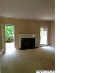 Family room with fireplace and door to open deck.