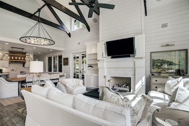 Open living area encompasses living, dining and kitchen, high level of appointments and characterful architectural details include quality built ins, shiplap, decorative ceiling beams and amazing light fittings .