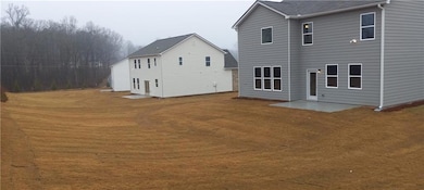Rear view of property featuring a patio area
