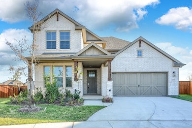 Craftsman-style house with concrete driveway, a shingled roof, brick siding, and a garage