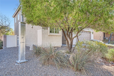 View of front of home with stucco siding, an attac