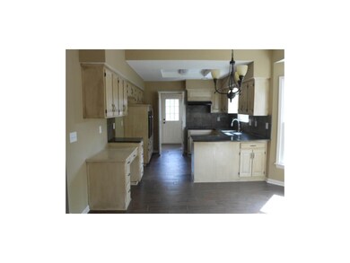 Eat-in kitchen.  Ceramic tile flooring that looks 
