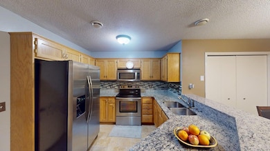 Kitchen w/granite countertops & SS appliances