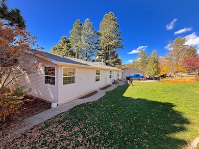 Rear view of house with a lawn