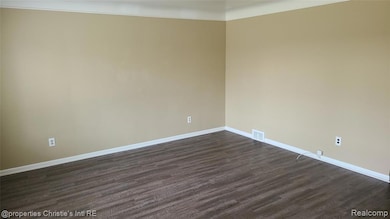Unfurnished room featuring dark wood-type flooring and baseboards