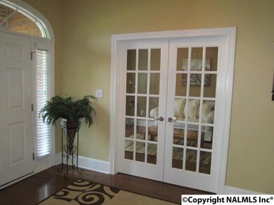 French doors welcome you to the Living Room/Study with hardwoods and crown moulding.