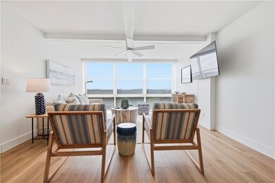 Sitting room featuring wood finished floors, beam ceiling, and ceiling fan