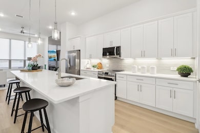 Kitchen with a center island with sink, stainless 