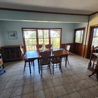 Dining space featuring a textured ceiling, a healt