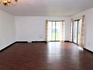 Spacious Living Room/Dining Room combo with two sets of sliding doors to the fenced back yard and patio.