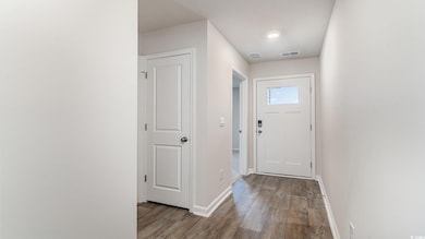 Entryway with hardwood / wood-style floors