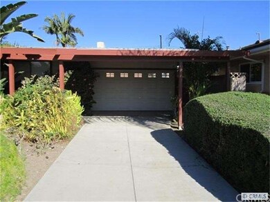 Front of drive-thru 2 car garage-carport