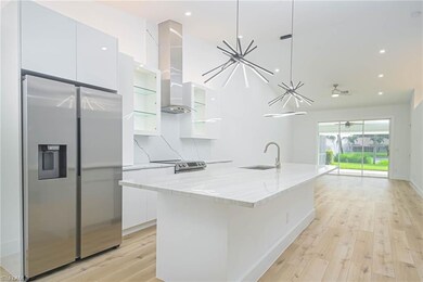 Kitchen with modern cabinets, white cabinetry, a k