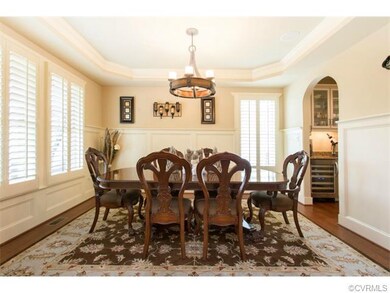 Formal dining, accented by custom lighting & plant