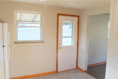 MORE KITCHEN SHOWING DOOR TO SIDE, COVERED PORCH W