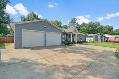 View of front of house with a garage and a front y