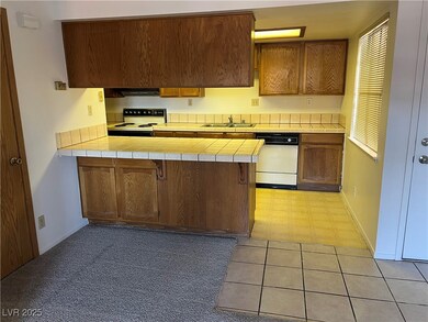 Kitchen with white dishwasher, electric range oven