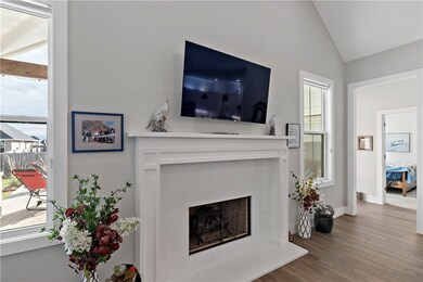 Living room with lofted ceiling, a high end firepl