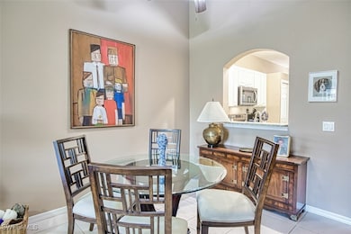 Dining area featuring ceiling fan, arched walkways