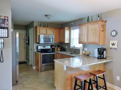 This kitchen has been remodeled by the sellers.  Stainless steel appliances all remain.  Tile laid on the diagonal  accents the floor in the kitchen, breakfast room,& half bath. Granite graces the countertops & a new stainless steel sink & faucet has been installed.