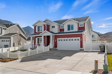 View of front of property featuring a mountain view, concrete driveway, an attached garage, and a gate