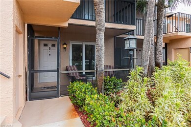 View of exterior entry featuring stucco siding and a balcony