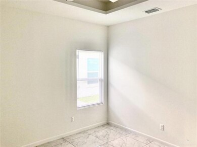 Spare room featuring baseboards and light marble finish flooring