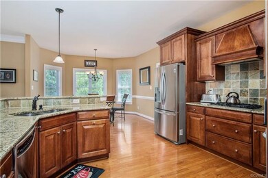 A chef's kitchen with upgraded cabinets, granite c