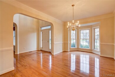 Dining Room - Hardwood Floors, Crown and Chair Moudling, Bay Window, Chandelier Lighting